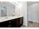 Bathroom includes double sink vanity, large mirror, and glass-enclosed shower stall at 260 Lake Smart Cir, Winter Haven, FL 33881