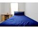 Bedroom with a bed, wooden floors, a window, and a shelf with baseball equipment at 260 Lake Smart Cir, Winter Haven, FL 33881