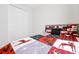 A cozy bedroom featuring a bed with a colorful quilt and a closet with white folding doors at 260 Lake Smart Cir, Winter Haven, FL 33881