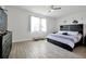 Bright bedroom shows wood-look flooring, a ceiling fan, and decorative elements on the wall at 260 Lake Smart Cir, Winter Haven, FL 33881