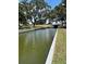 Scenic canal view featuring concrete embankments, trees, and water leading to a water tunnel at 260 Lake Smart Cir, Winter Haven, FL 33881