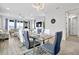 Bright dining room showcases glass table and transitions to living room with plush sofa at 260 Lake Smart Cir, Winter Haven, FL 33881