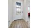 Bright entryway with decorative front door and light wood-look tile flooring at 260 Lake Smart Cir, Winter Haven, FL 33881