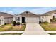 Charming single-Gathering home features a two-car garage, well-kept lawn, and inviting curb appeal at 260 Lake Smart Cir, Winter Haven, FL 33881