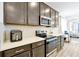 Well-equipped kitchen with stainless steel appliances, dark cabinetry, and a breakfast bar at 260 Lake Smart Cir, Winter Haven, FL 33881