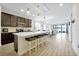 Stylish kitchen featuring an island with seating, stainless steel appliances, and a view into the living room at 260 Lake Smart Cir, Winter Haven, FL 33881