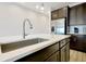 Modern kitchen island boasts stainless sink, white countertop and sleek faucet fixture at 260 Lake Smart Cir, Winter Haven, FL 33881