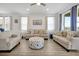 Comfortable living room featuring neutral furniture, tile floors, and bright, natural light at 260 Lake Smart Cir, Winter Haven, FL 33881