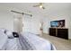 Bedroom featuring a sliding barn door and TV over dresser with wood-look floors at 260 Lake Smart Cir, Winter Haven, FL 33881