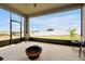 Screened patio features an outdoor fire pit and views of the fenced backyard and lake at 260 Lake Smart Cir, Winter Haven, FL 33881