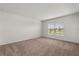 Cozy bedroom with neutral carpet, a window with a view, and ample natural light at 3823 Pronghorn Dr, St Cloud, FL 34772