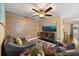 Comfortable living room with hardwood floors, leather furniture, TV, and decorative rug at 5000 Ashford Falls Ln, Oviedo, FL 32765