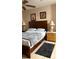Warm bedroom with a ceiling fan, two side tables, and artwork at 5471 Vineland Rd # 7109, Orlando, FL 32811