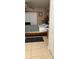 Bedroom with ceiling fan, neutral walls, a patterned bed spread, and dark rug at 5471 Vineland Rd # 7109, Orlando, FL 32811
