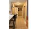 Hallway view with neutral paint, showcasing access to kitchen at 5471 Vineland Rd # 7109, Orlando, FL 32811