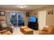 Cozy living room with comfortable seating, tile flooring, and access to an outdoor patio at 5471 Vineland Rd # 7109, Orlando, FL 32811