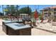 Community pool featuring a gas grill, stone accents, and lounge chairs at 5471 Vineland Rd # 7109, Orlando, FL 32811