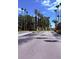 Scenic entry drive showcases meticulous landscaping leading to property entrance at 5471 Vineland Rd # 7109, Orlando, FL 32811