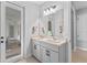 Bright bathroom features a double sink vanity and natural light, with a door leading to the outdoor space at 5981 Sierra Crown St, Mount Dora, FL 32757