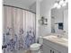 Clean bathroom featuring a shower with a floral curtain, a toilet, and a sink with a mirror at 5981 Sierra Crown St, Mount Dora, FL 32757