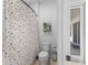 Cozy bathroom features a polka dot shower curtain, toilet, and floating shelf, providing a functional space at 5981 Sierra Crown St, Mount Dora, FL 32757