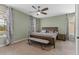 Calming bedroom featuring soft green walls, a king-sized bed, and elegant curtains for a peaceful retreat at 5981 Sierra Crown St, Mount Dora, FL 32757