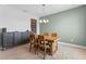 Dining room showcases wood table, chairs, and sideboard; carpet and pastel green accent wall at 5981 Sierra Crown St, Mount Dora, FL 32757