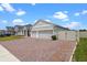 The exterior features a 3 car garage and a brick driveway at 5981 Sierra Crown St, Mount Dora, FL 32757