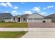 Charming single-story home featuring a two-car garage, brick-paved driveway, and well-manicured lawn at 5981 Sierra Crown St, Mount Dora, FL 32757