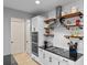 Detailed shot of modern kitchen features, with floating shelves and stainless steel appliances at 5981 Sierra Crown St, Mount Dora, FL 32757