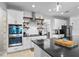 Well-appointed kitchen with a double oven, custom shelving, and a large center island with seating at 5981 Sierra Crown St, Mount Dora, FL 32757