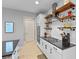 Close-up of modern kitchen with open shelving, stainless steel appliances, and sleek countertops at 5981 Sierra Crown St, Mount Dora, FL 32757