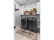 Functional laundry room with shelving, modern washer and dryer, and laundry-themed decor on a floor mat at 5981 Sierra Crown St, Mount Dora, FL 32757