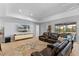 Spacious living room with plush leather seating, carpeted floors, and a sliding glass door with a view at 5981 Sierra Crown St, Mount Dora, FL 32757