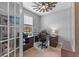 Well-lit home office with a large desk, ergonomic chair, and ceiling fan at 5981 Sierra Crown St, Mount Dora, FL 32757