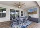 Outdoor dining area with comfortable seating, a ceiling fan, and a television, perfect for entertaining at 5981 Sierra Crown St, Mount Dora, FL 32757