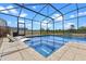 Screened-in pool with waterfall feature and lounge chairs, providing a refreshing outdoor oasis at 5981 Sierra Crown St, Mount Dora, FL 32757