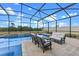 A screened-in pool features a seating area with an outdoor fireplace at 5981 Sierra Crown St, Mount Dora, FL 32757
