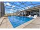 A screened pool sits in front of the house and boasts tanning ledge and outdoor seating area at 5981 Sierra Crown St, Mount Dora, FL 32757