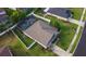 A home with a screen-enclosed pool is featured from an aerial perspective, surrounded by a white fence at 690 Cascading Creek Ln, Winter Garden, FL 34787