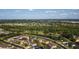 An aerial perspective showing a suburban community nestled amidst lush greenery and serene water features at 690 Cascading Creek Ln, Winter Garden, FL 34787