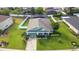 Aerial view of a well-maintained home with a screened-in pool, manicured lawn, and mature trees at 690 Cascading Creek Ln, Winter Garden, FL 34787