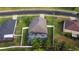 Overhead view of home with a screen-enclosed pool, fenced yard, and pristine landscaping at 690 Cascading Creek Ln, Winter Garden, FL 34787