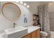 Bright bathroom features a vessel sink, stylish mirror, and patterned shower curtain at 690 Cascading Creek Ln, Winter Garden, FL 34787