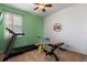 Bright exercise room with a treadmill, stationary bike, and weight bench at 690 Cascading Creek Ln, Winter Garden, FL 34787