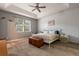 Light-filled bedroom featuring a white metal bed frame and a wooden storage chest at 690 Cascading Creek Ln, Winter Garden, FL 34787