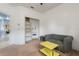 Sitting room with a comfortable olive sofa and a sunny yellow table at 690 Cascading Creek Ln, Winter Garden, FL 34787