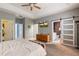 Bedroom featuring walk-in closet, ensuite bath, and a ceiling fan at 690 Cascading Creek Ln, Winter Garden, FL 34787