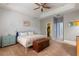 Light-filled bedroom featuring a white metal bed frame and a wooden storage chest at 690 Cascading Creek Ln, Winter Garden, FL 34787
