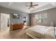 Bedroom featuring walk-in closet, ensuite bath, and a ceiling fan at 690 Cascading Creek Ln, Winter Garden, FL 34787